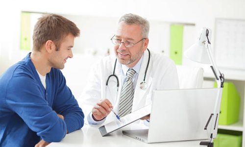 Doctor showing form to male patient at his office.See more LIFESTYLE and MEDICAL images with this COUPLE and DOCTOR or CONSULTANT. Click on image below for lightbox.
